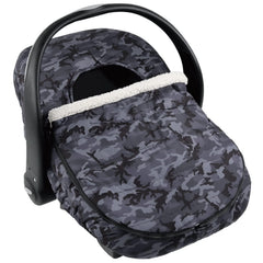 The Peanutshell car seat cover in use providing 360-degree warmth for baby