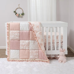 The Peanutshell Grace quilt close-up shows textured patchwork for a cozy nursery accent.