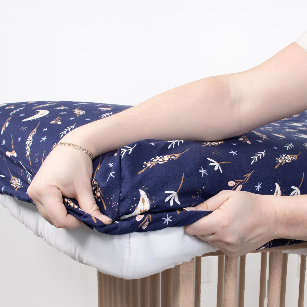 The Peanutshell Lunar Love crib sheet on a standard 52x28 mattress during nap time.
