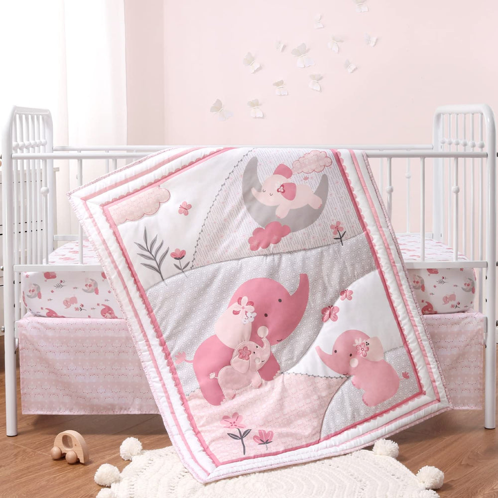 The Peanutshell pink elephant crib quilt close-up shows soft fabric for gentle sleep.