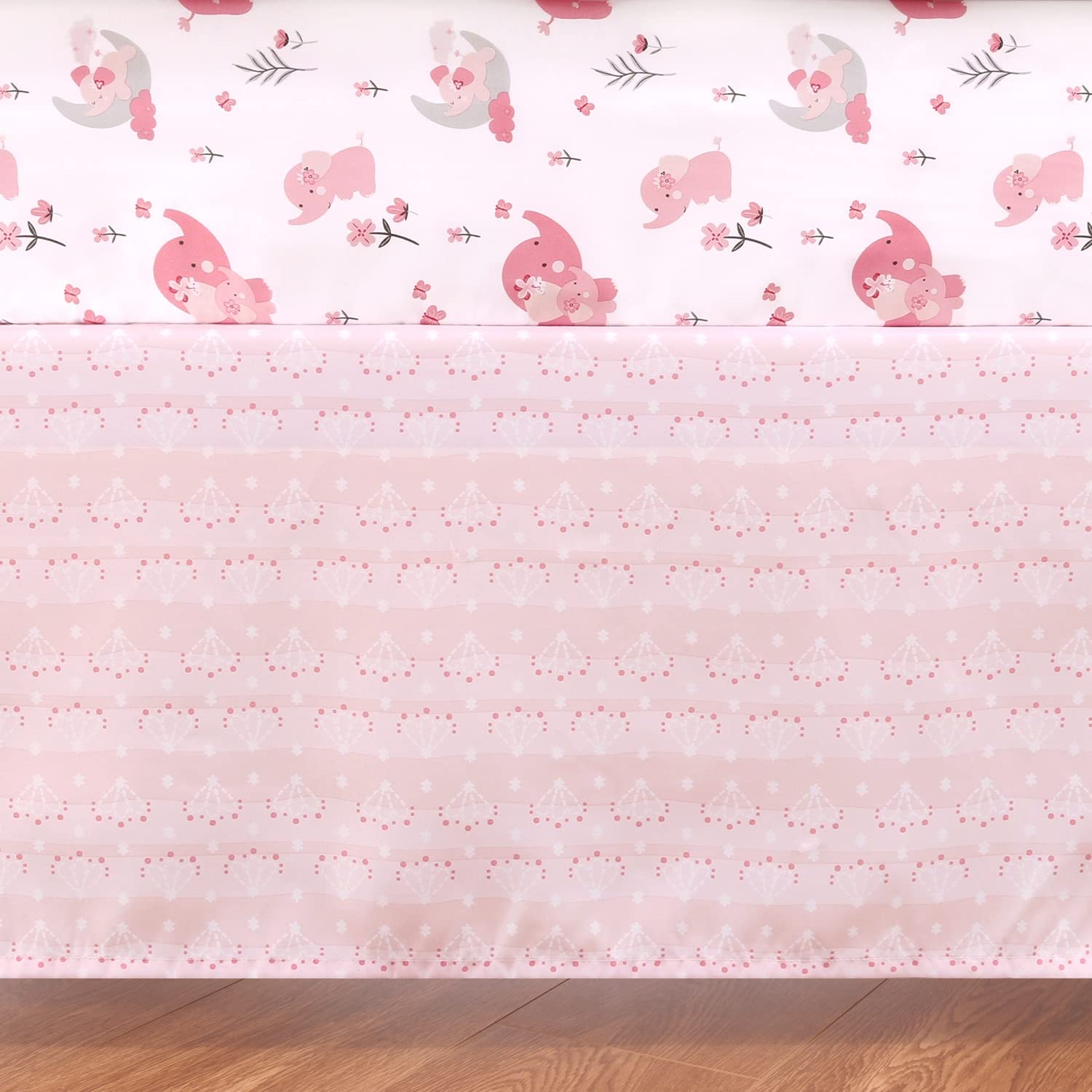 The Peanutshell pink elephant crib quilt detail highlighting print and cozy texture.