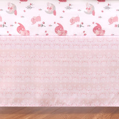 The Peanutshell pink elephant crib quilt detail highlighting print and cozy texture.