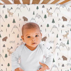 The Peanutshell woodland camo bed skirt enhances nursery decor while concealing under-bed storage.