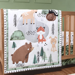 The Peanutshell woodland camo crib quilt with forest animals adds cozy warmth for nap time.