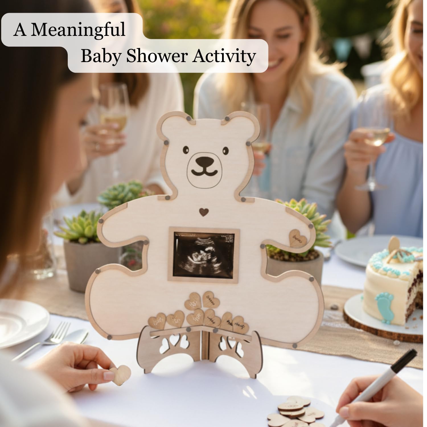 The Real Bossy Baby wooden token box with heart tokens for guest signatures.