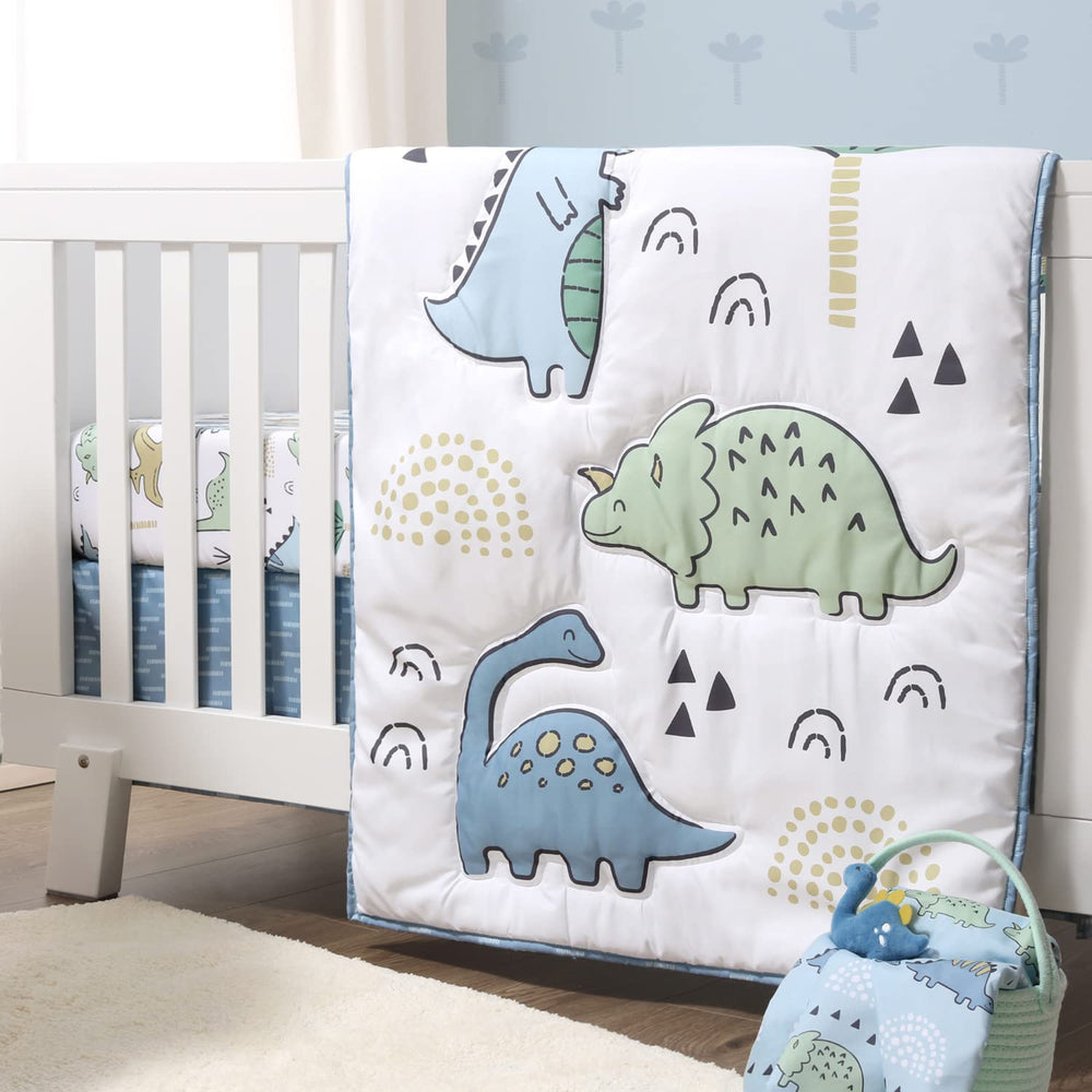 The Peanutshell blue dino bed skirt helps tidy under-crib space while styling.