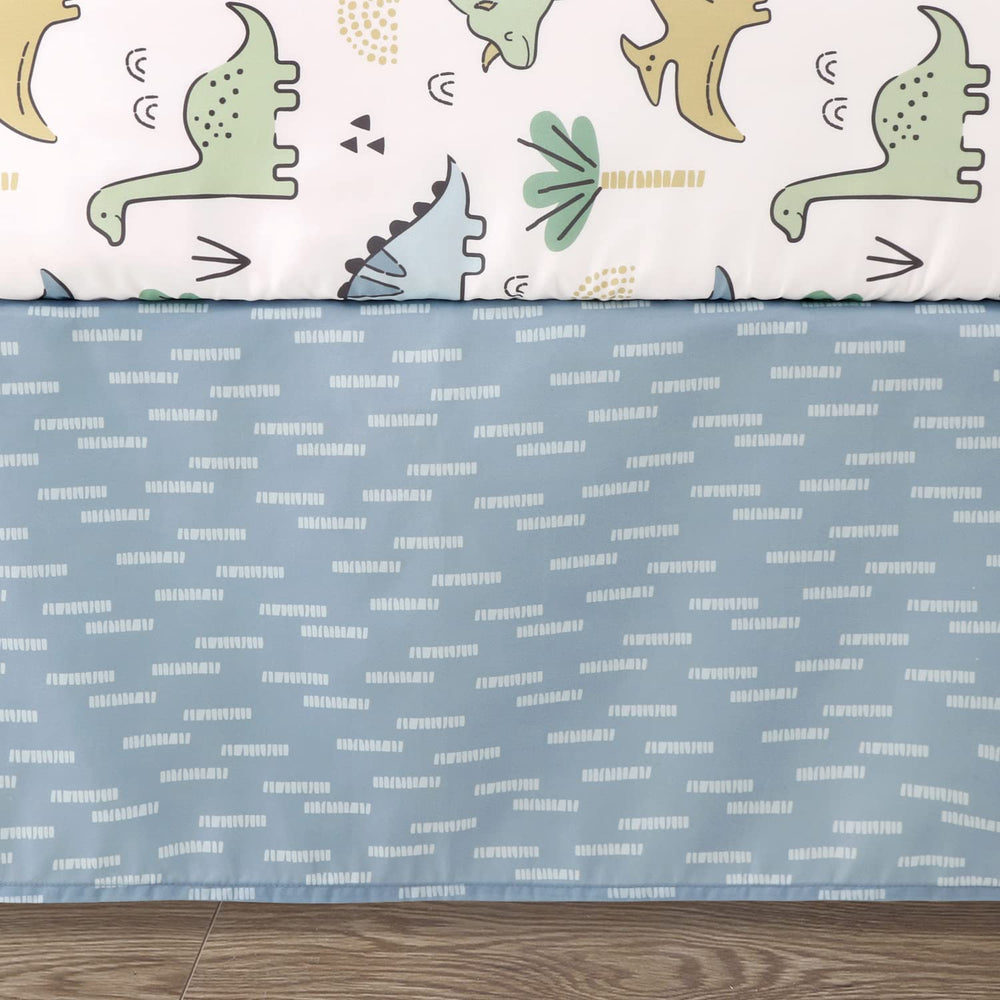 The Peanutshell blue dino dust ruffle finishes the crib look with tidy detail.