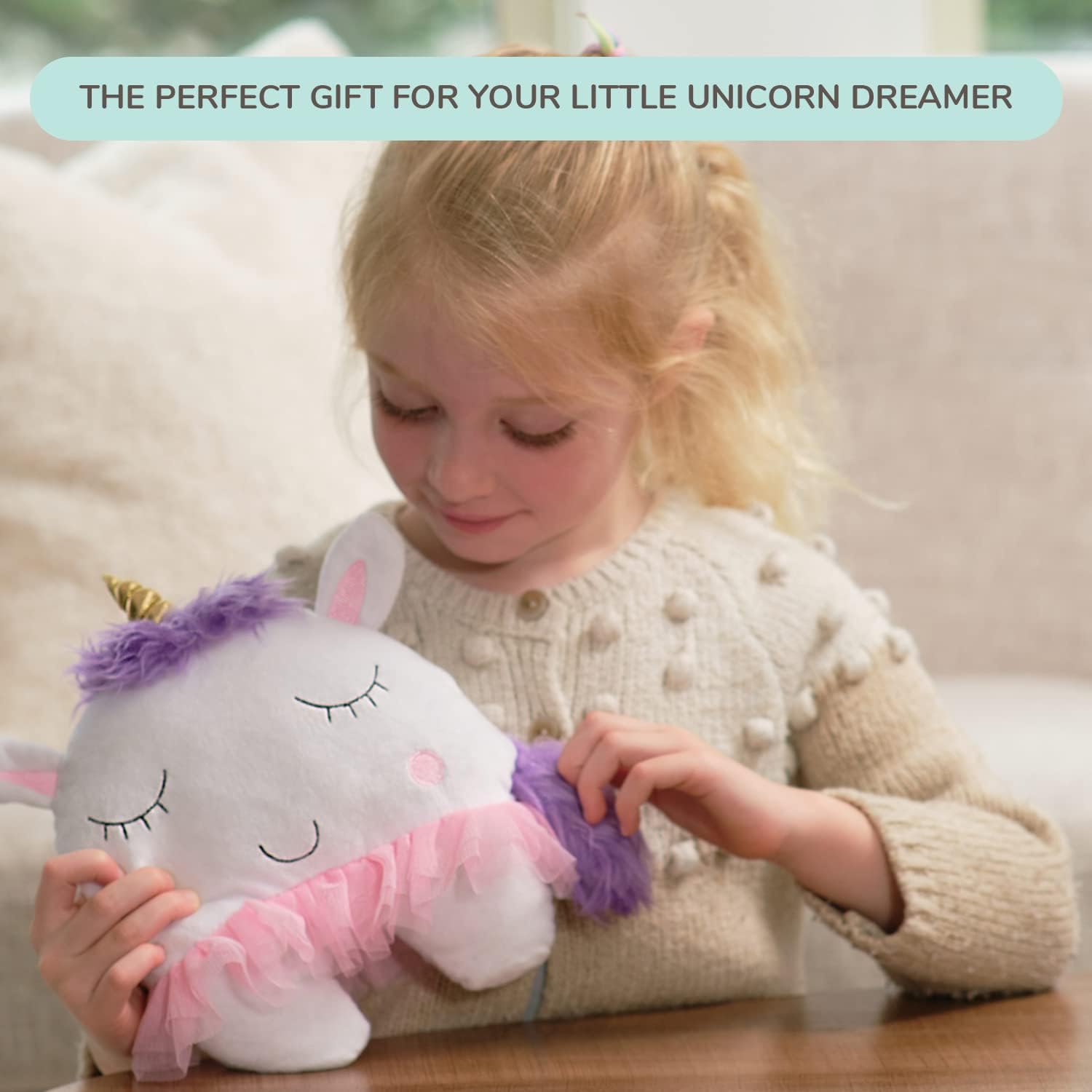 Tickle and Main hanging unicorn pillow in a child's room decor setting.