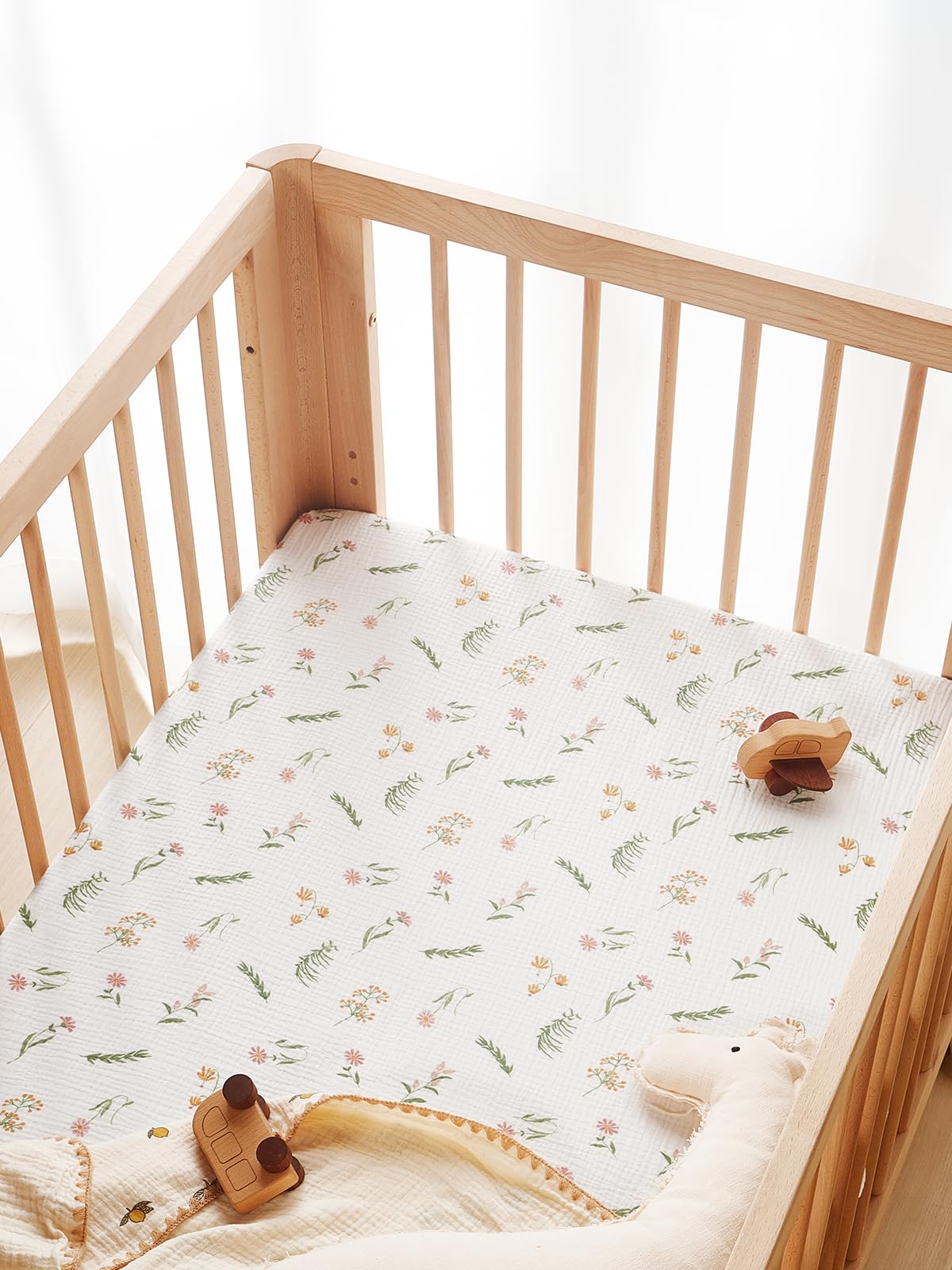 TILLYOU Daisy crib sheet texture reveals lightweight cotton for comfortable sleep.