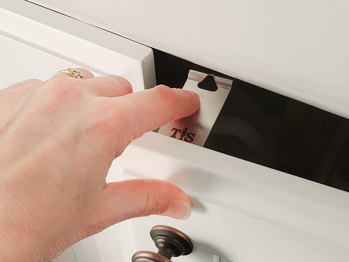 Tin Soldier latch inside cabinet close-up demonstrates discreet safety for kids and pets.