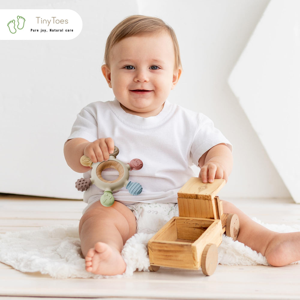 Tiny Toes teether bright colors and fun shapes stimulate curiosity during early infant play.