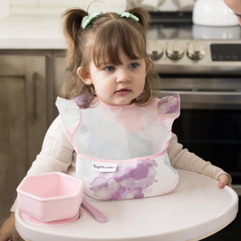 tiny twinkle baby apron feeding scene illustrates easy cleanups after busy bite sessions.