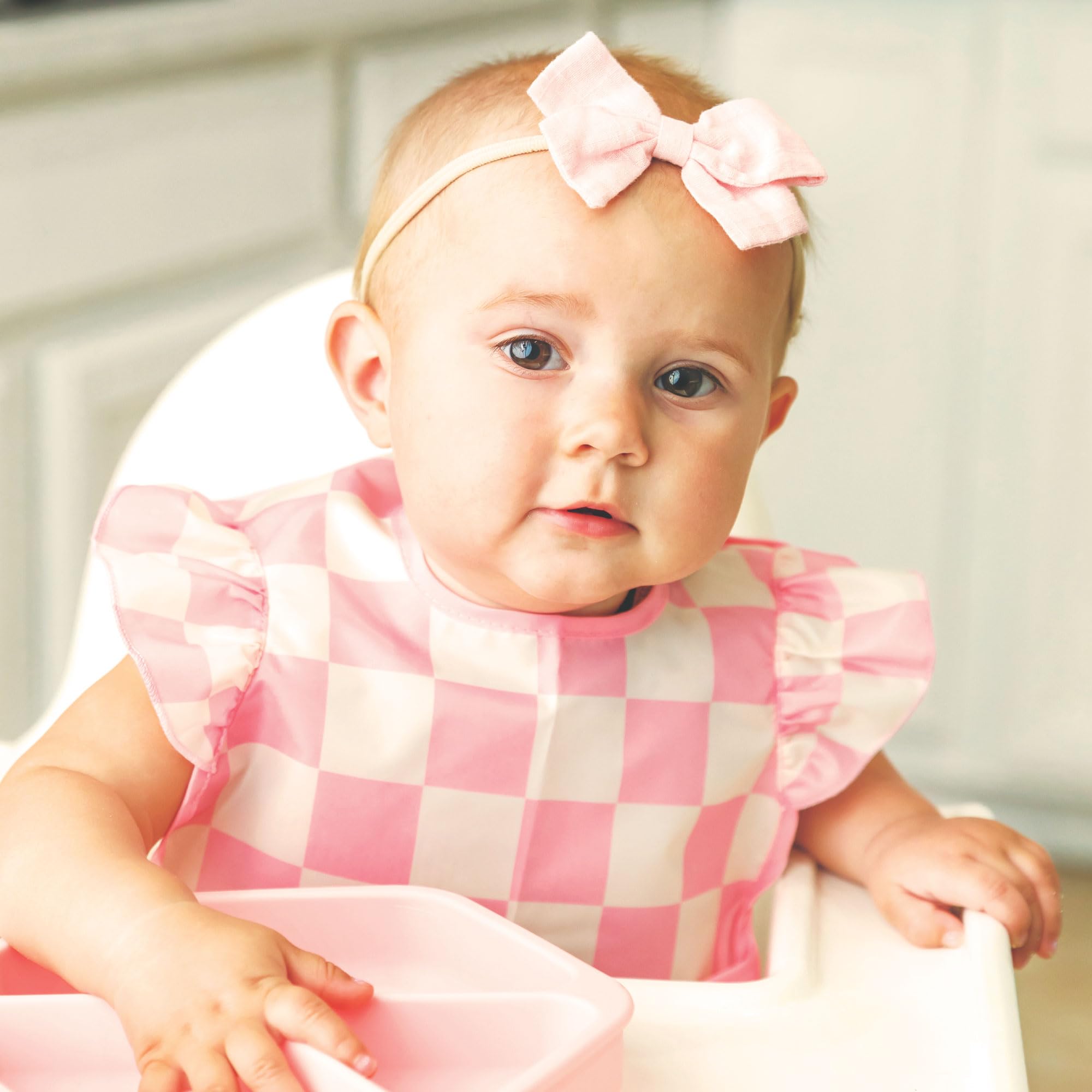 Tiny Twinkle lightweight water-repellent bib ready for everyday use.