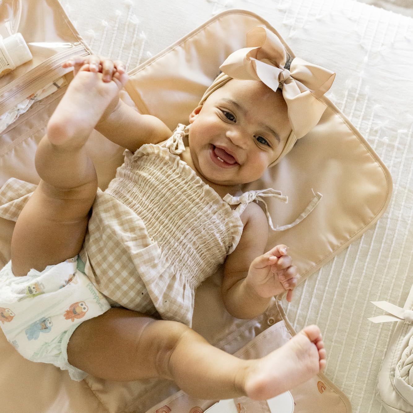 Tiny Twinkle organized storage pockets keep diapers and creams within reach during trips.