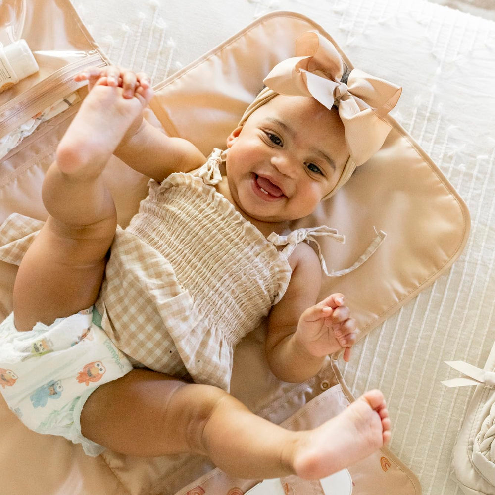 Tiny Twinkle organized storage pockets keep diapers and creams within reach during trips.