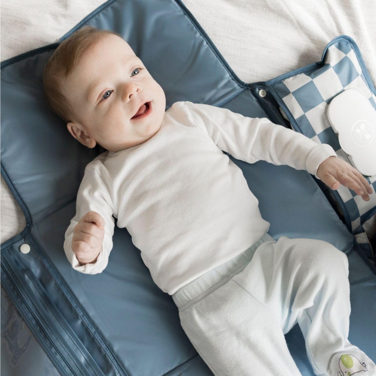 Tiny Twinkle changing pad organized pockets keep diapers, creams, and wipes neatly within reach.