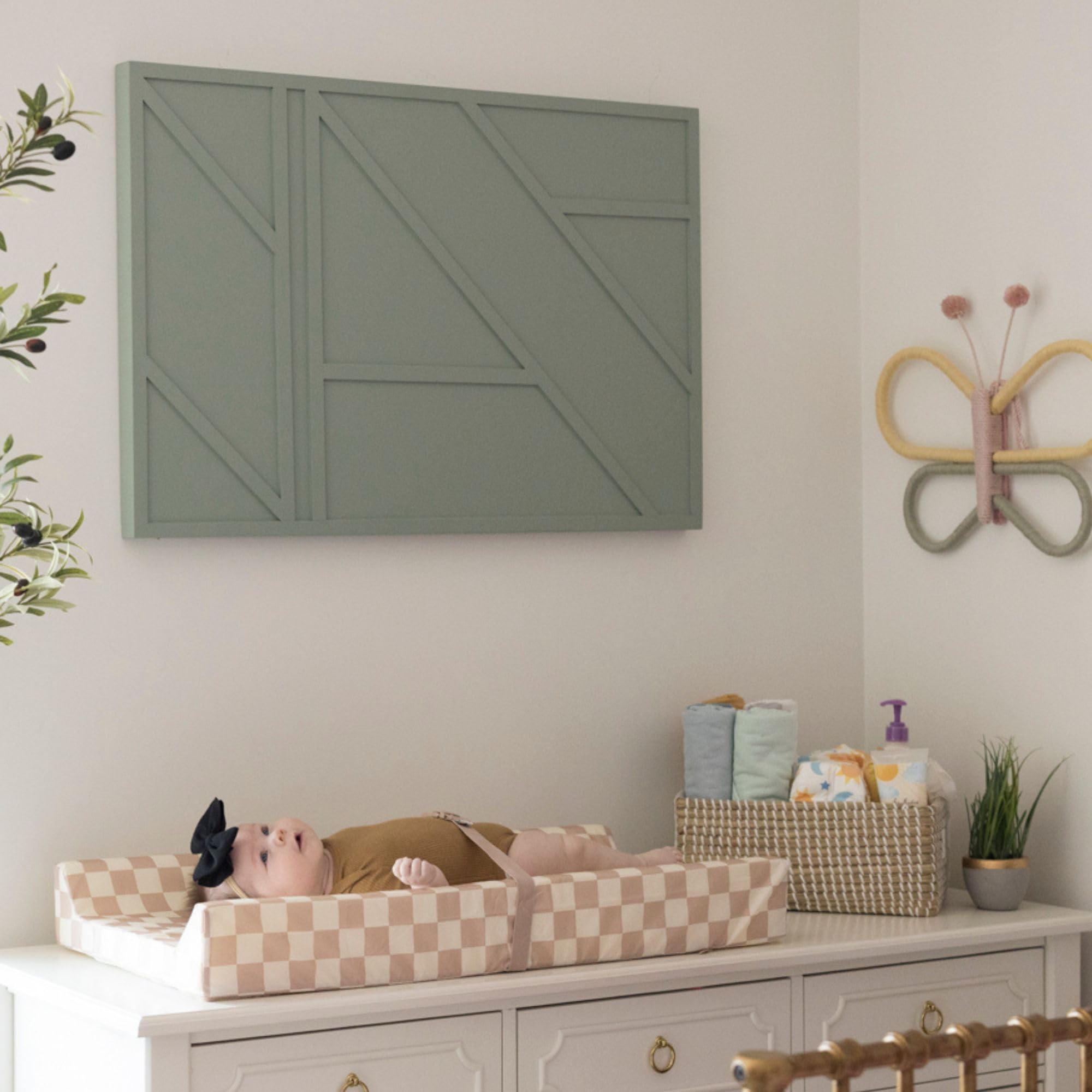 Tiny Twinkle beige checkers pad complements nursery decor and stays practical.