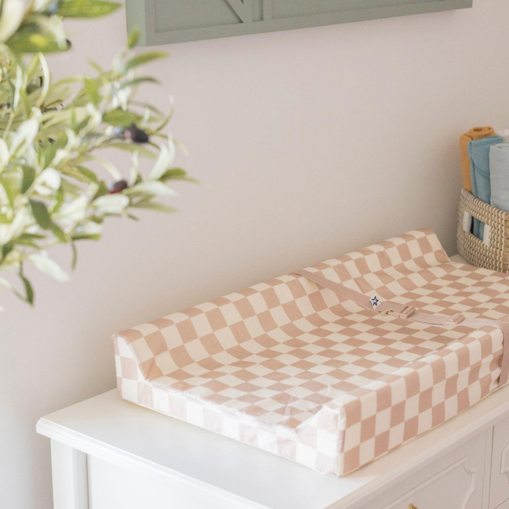 Tiny Twinkle diaper changing pad with safety strap keeps baby secure during changes.