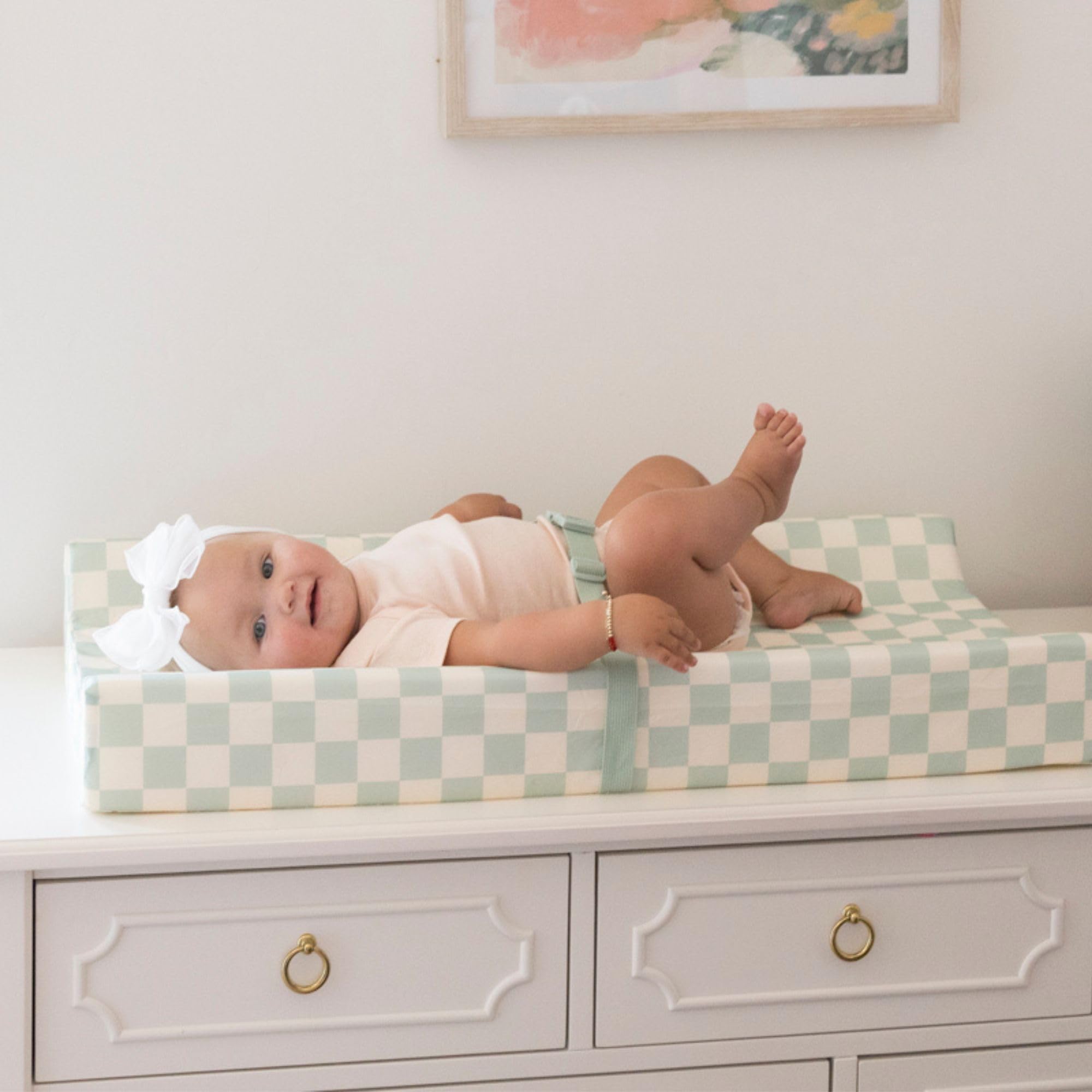 Tiny Twinkle changing pad safety strap secures baby during changes.