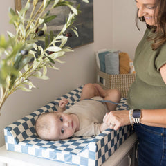 Tiny Twinkle changing pad with safety strap stays secure during diaper changes.