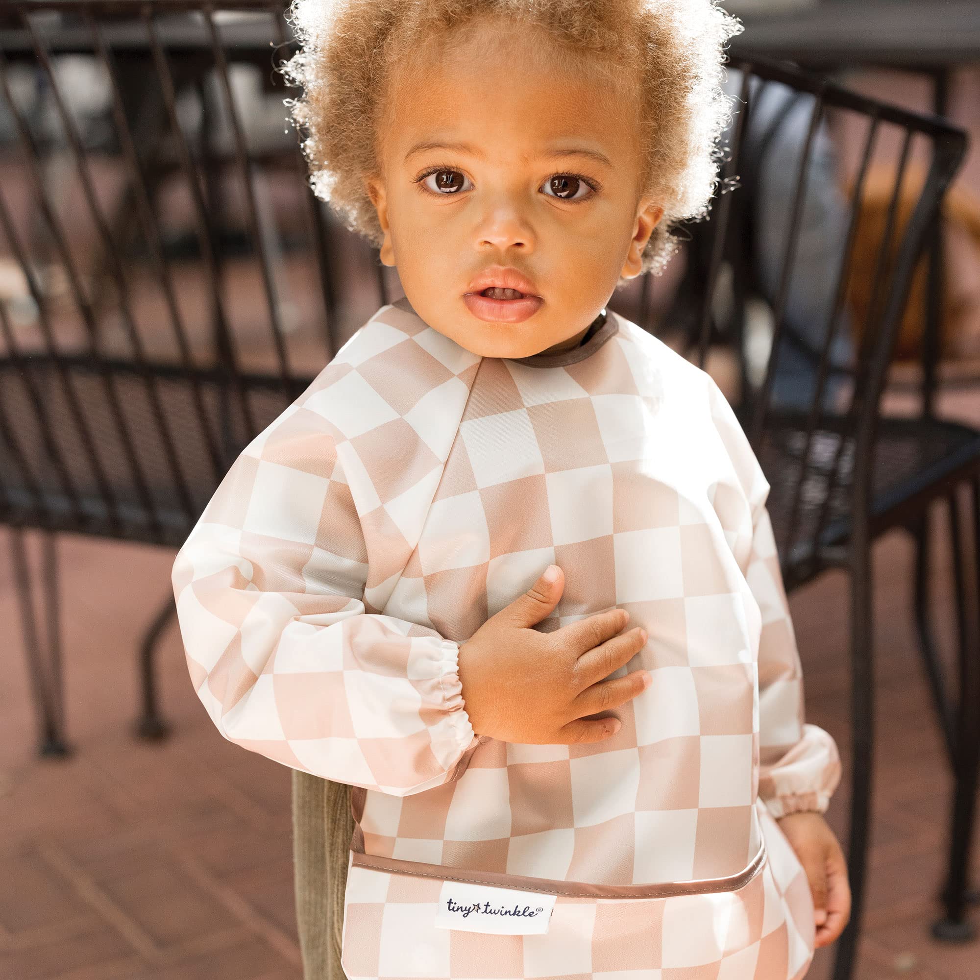 Tiny Twinkle elastic cuffs on baby bib capture sleeves and keep clothes clean.