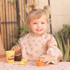 Tiny Twinkle long-sleeve bib closeup of waterproof fabric demonstrating spill protection during meals.