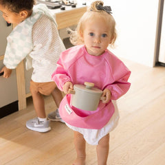 Tiny Twinkle elastic cuffs closeup shows mess-proof sealing around wrists for playtime and meals