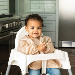 Tiny Twinkle long-sleeve bib sand cinnamon cuff-detail close-up with soft elastic cuffs for comfortable wear.
