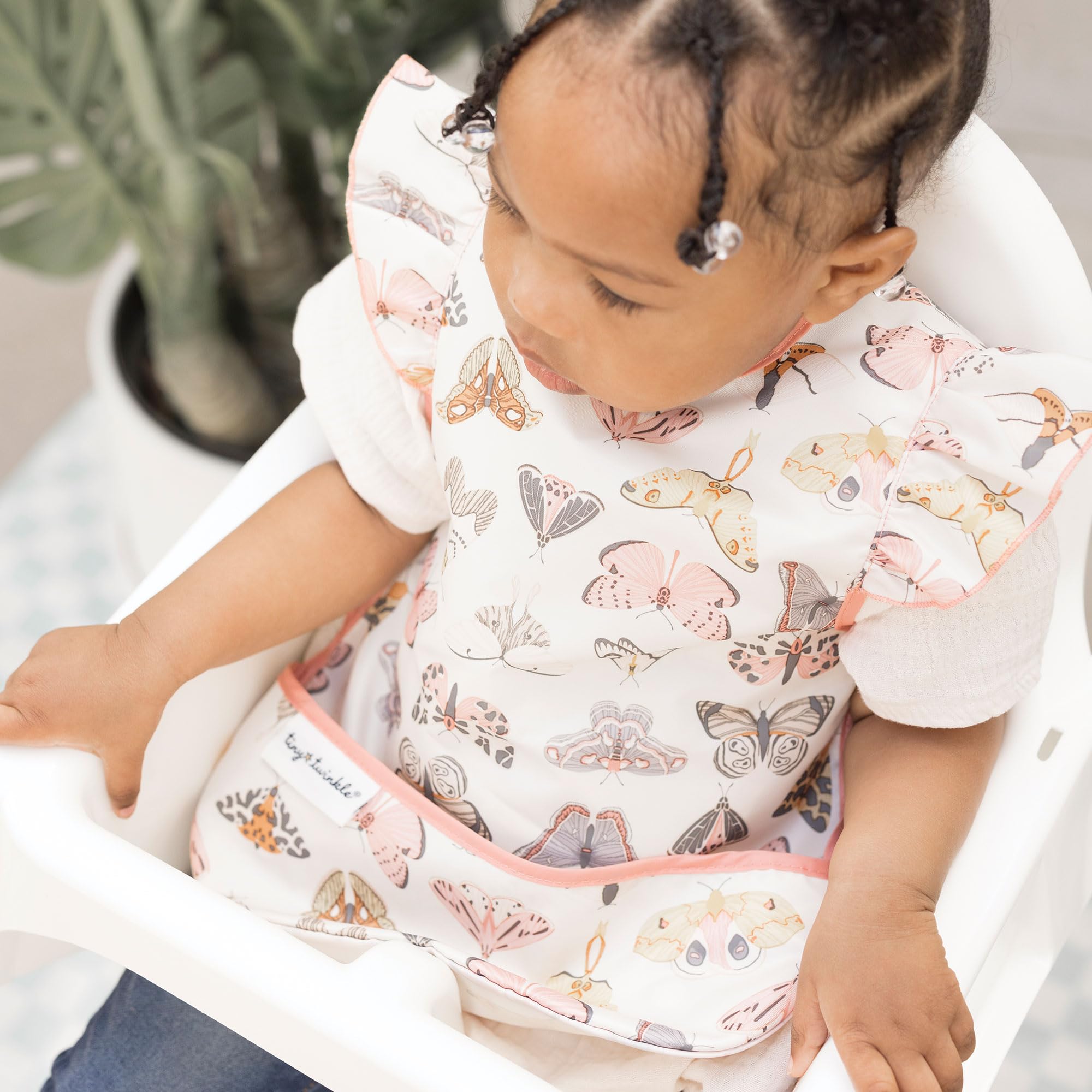 Tiny Twinkle machine-washable baby apron cleaning ease demonstrates quick refresh after messy meals.
