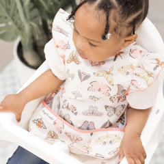 Tiny Twinkle machine-washable baby apron cleaning ease demonstrates quick refresh after messy meals.