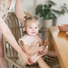 Tiny Twinkle machine-washable baby bib rose laundry-ready after messy meals.