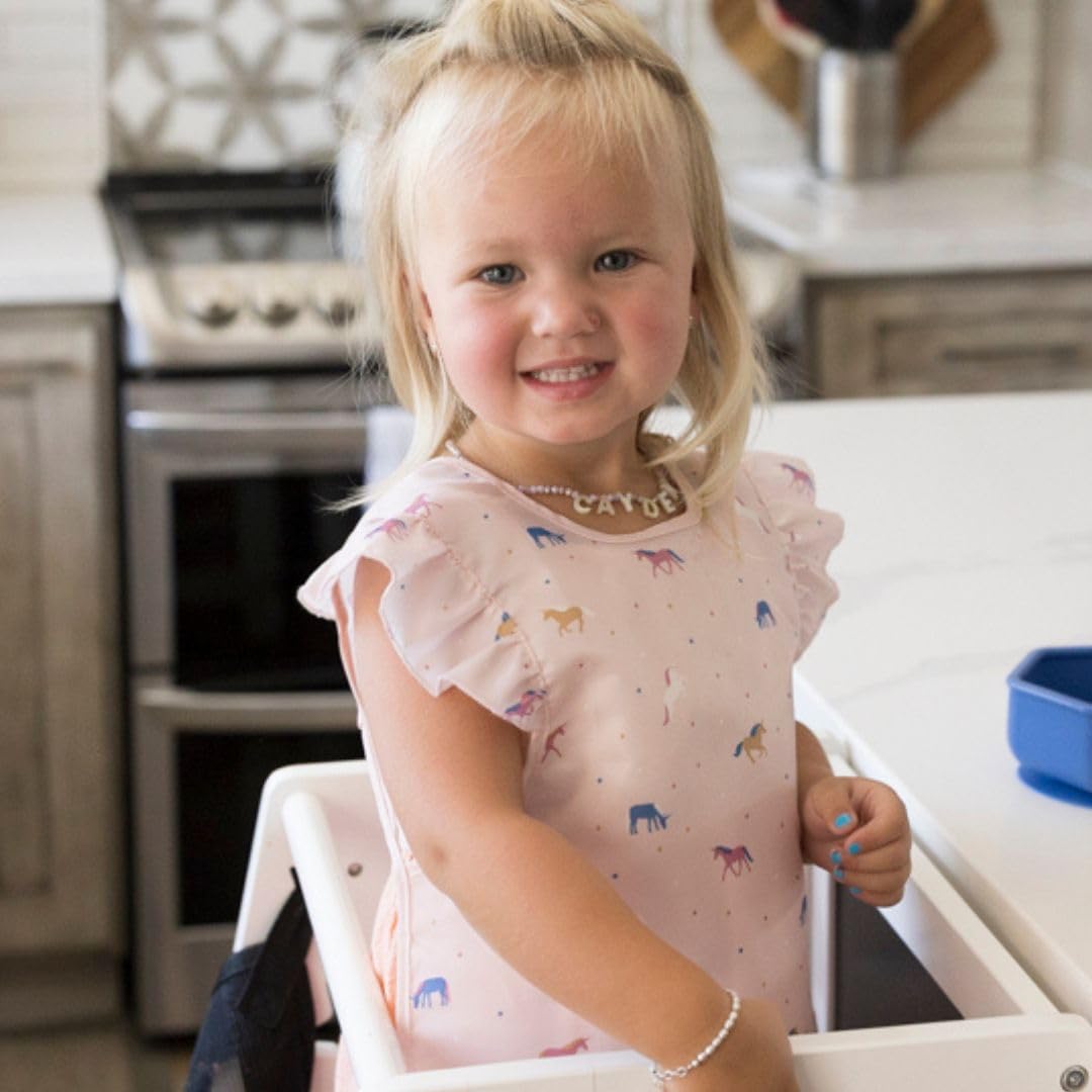 Tiny Twinkle mess-proof bib close-up highlights soft fabric and quick-clean surface.