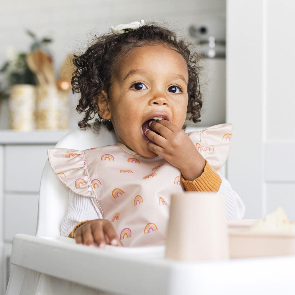 Tiny Twinkle Mess-Proof Bib offers flexible coverage for active toddlers at mealtime.