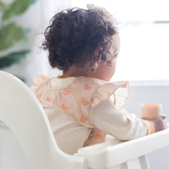 Tiny Twinkle Mess-Proof Bib is machine washable for quick refresh between meals.