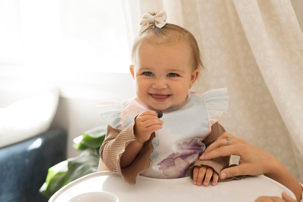 tiny twinkle mess proof bib mealtime fit demonstrates roomy design for growing toddlers.