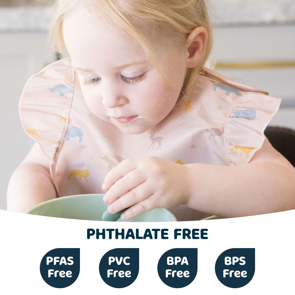 Tiny Twinkle bib on baby during mealtime highlighting waterproof fabric
