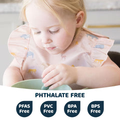 Tiny Twinkle bib on baby during mealtime highlighting waterproof fabric