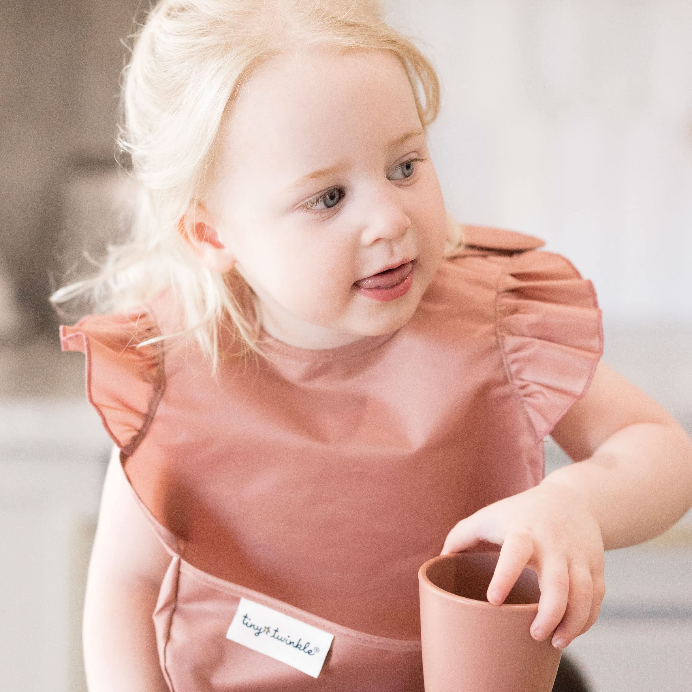 Tiny Twinkle Safari bib waterproof fabric demonstrates wipe-clean convenience