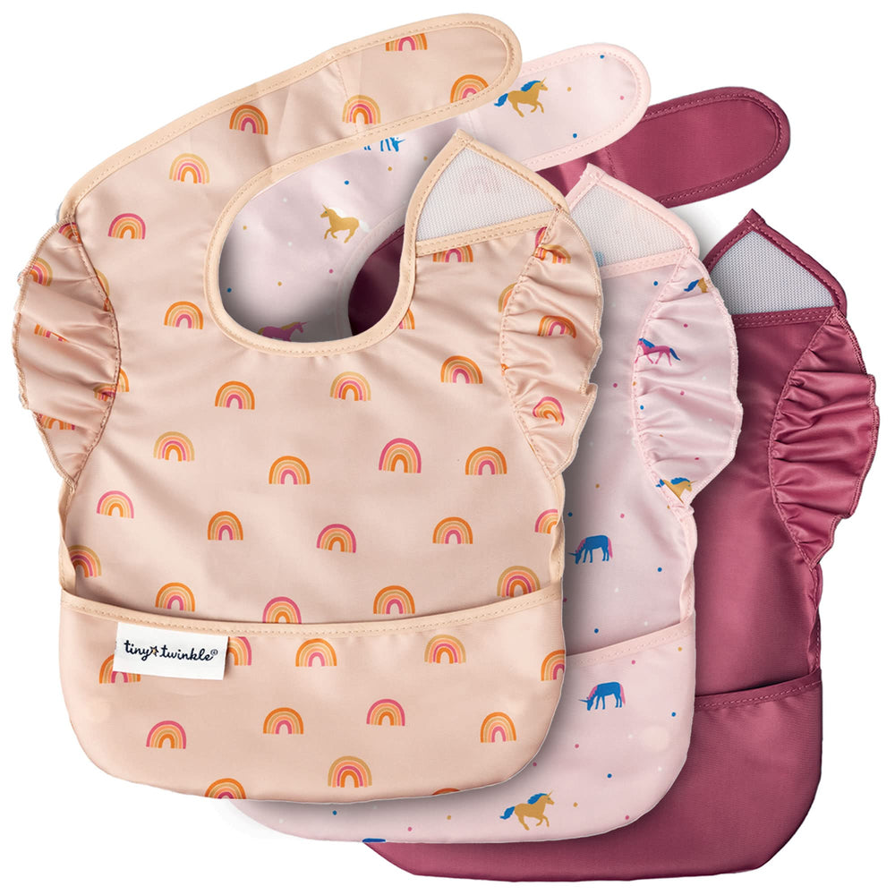 Tiny Twinkle mess-proof bib unicorn catch-pocket for mess containment during meals.