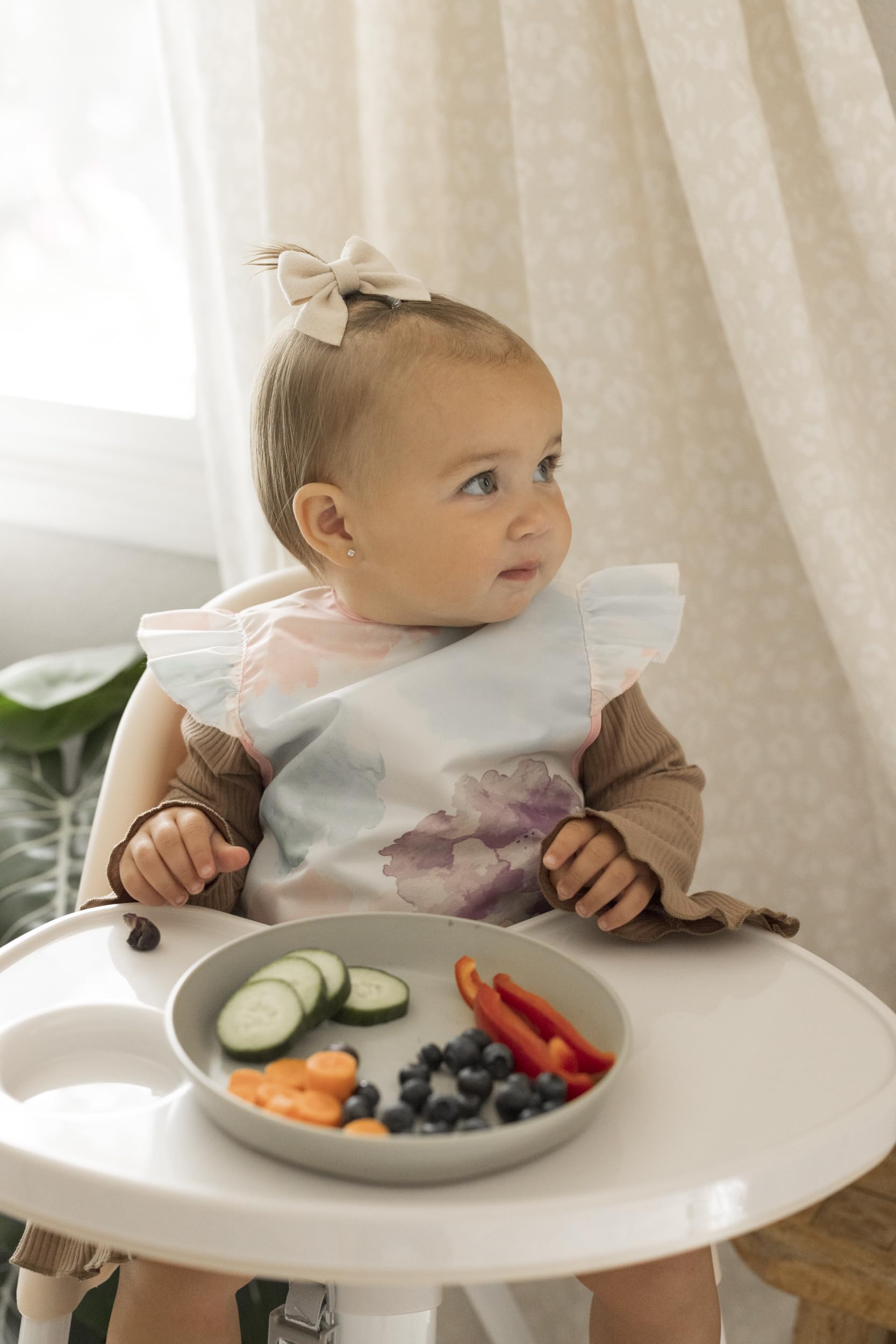 tiny twinkle mess proof bib waterproof back shows water-repellent layer during messy meals.