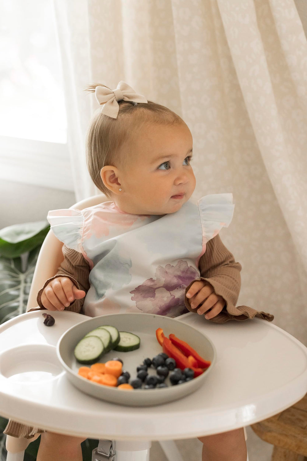 tiny twinkle mess proof bib waterproof back shows water-repellent layer during messy meals.