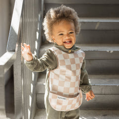 Tiny Twinkle Mess Proof Bib waterproof fabric close-up enables quick cleanup after spills.