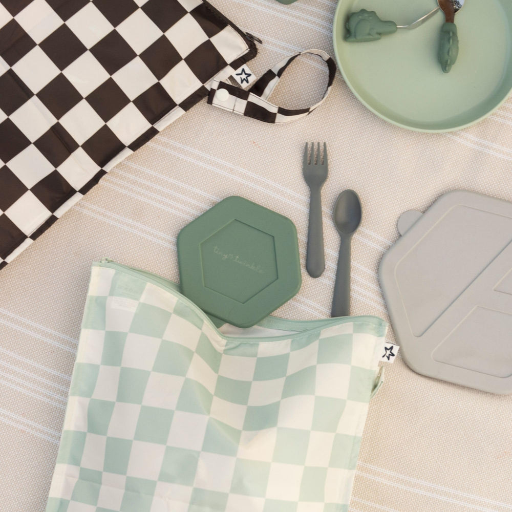 Tiny Twinkle Mess Proof Wet Bag open, black-green checkers, easy access for quick changes