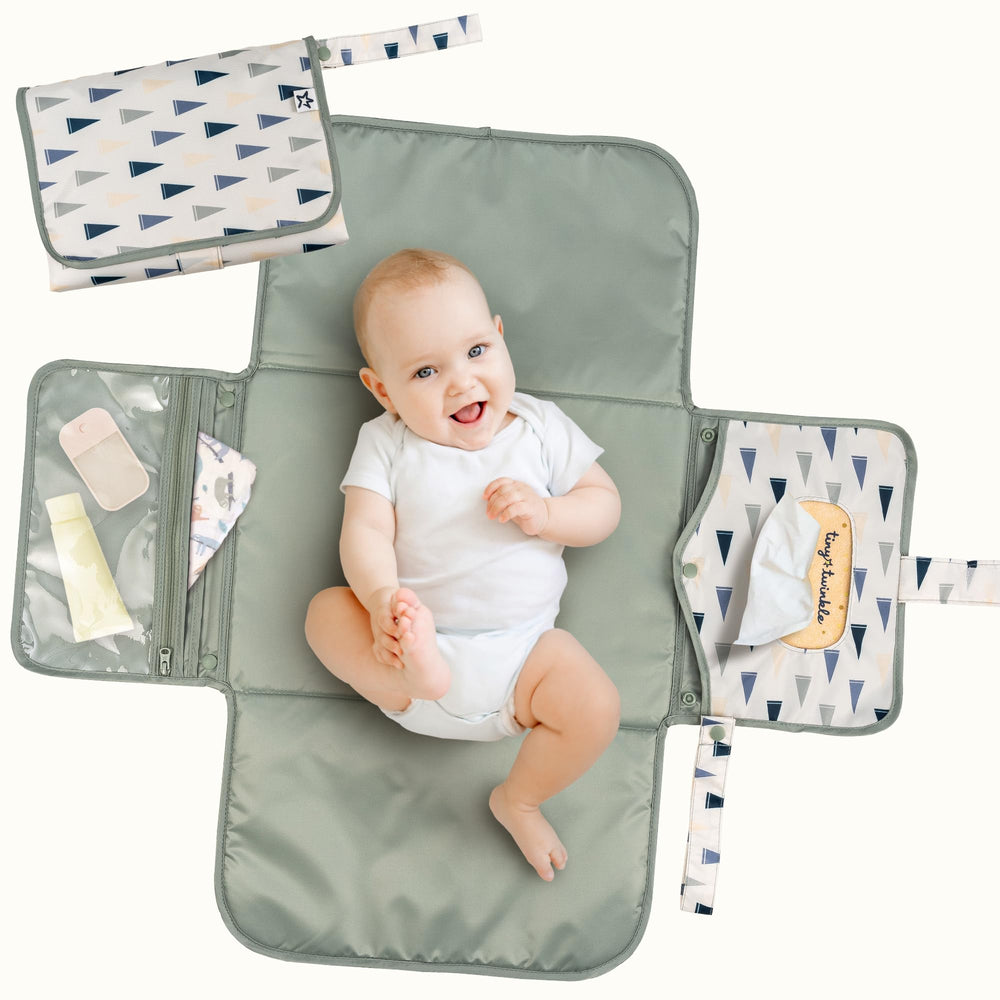Tiny Twinkle portable changing pad folds flat for compact travel storage.