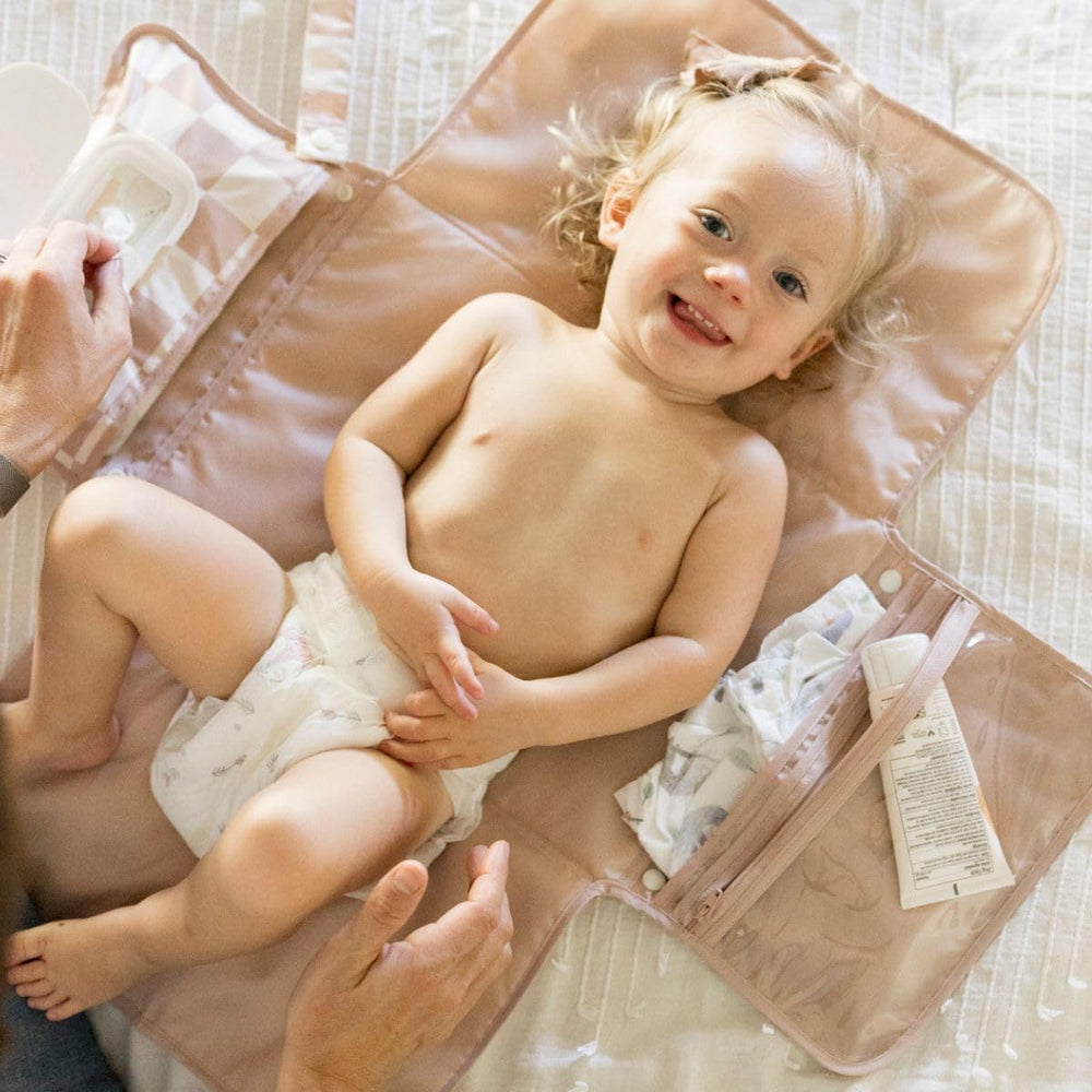Tiny Twinkle portable changing pad organized-storage pockets keep diapers and creams within reach.