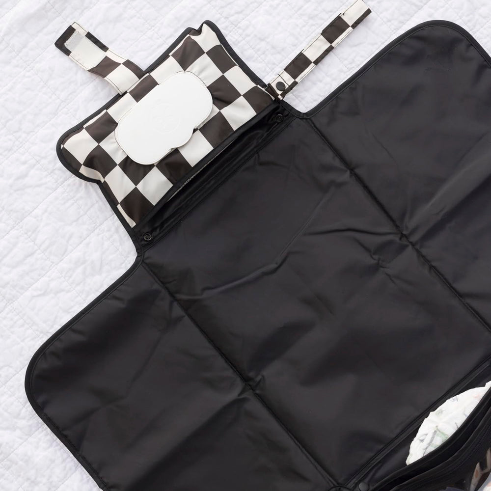Tiny Twinkle portable changing pad clipped to a stroller for hands-free changes