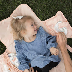 Tiny Twinkle portable changing pad clipped to a stroller for on-the-go convenience.