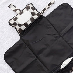 Tiny Twinkle portable changing pad clipped to a stroller for hands-free changes