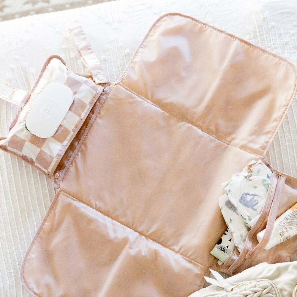 Tiny Twinkle portable changing pad travel-ready design supports changes on car trips and park visits.