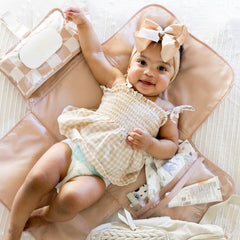 Tiny Twinkle portable changing pad waterproof surface keeps baby dry and surfaces clean.